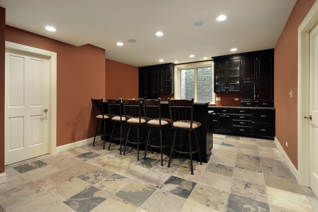 Bar in basement with dark wood cabinetry