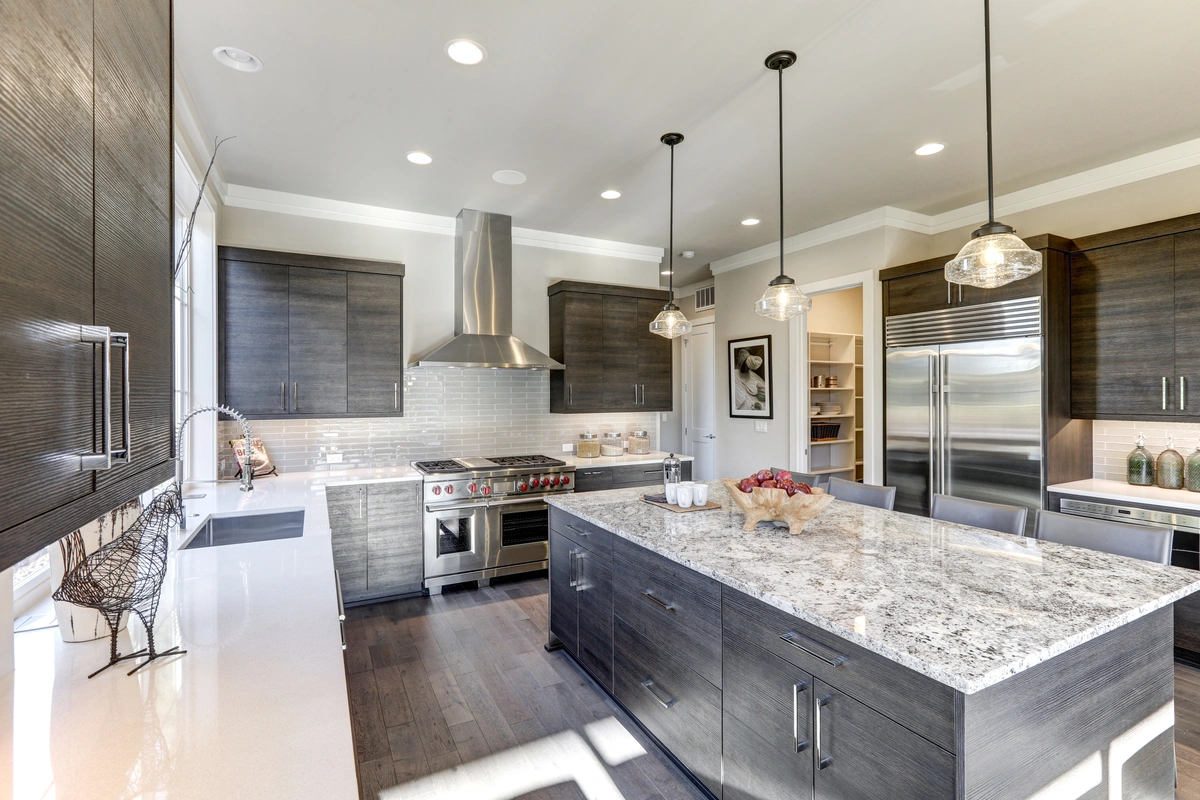 open concept kitchen with a bold granite island and good lighting