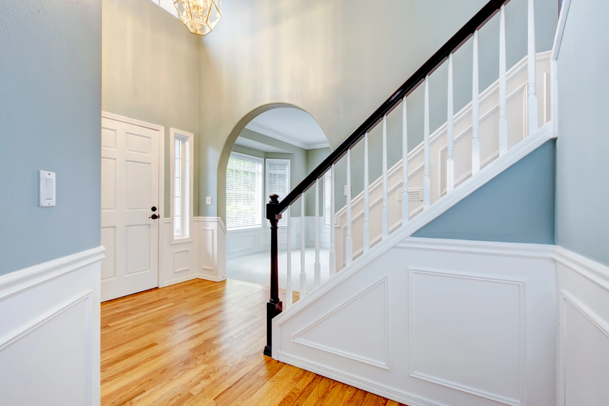 beautiful staircase remodel with white steps and black painted railing